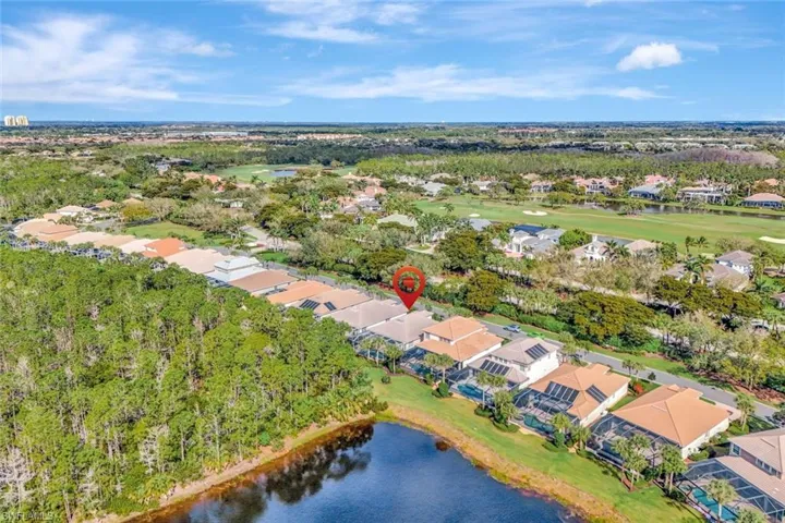 Drone / aerial view with a residential view, a water view, and golf course view