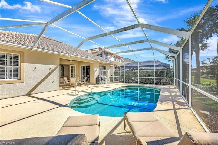 Pool with a lanai and a patio