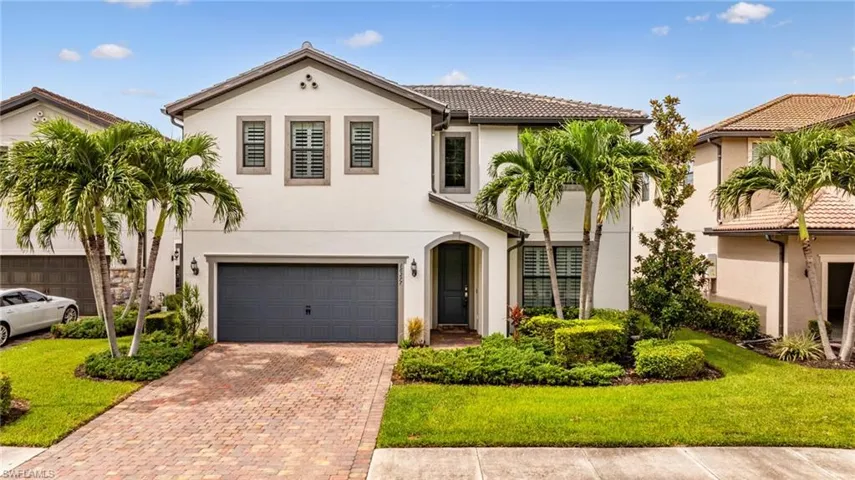 Contemporary white stucco exterior with a dark tile roof