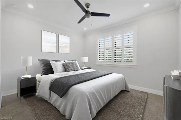 Bedroom featuring a window with white louvered shutters, crown molding, a ceiling fan, and recessed lighting