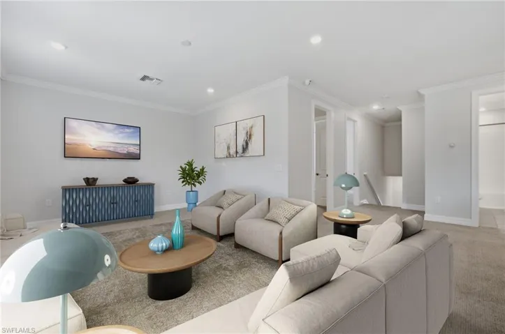 Spacious upper-level room featuring light gray walls, recessed lighting, crown molding, and carpeted flooring