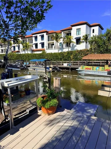 Dock area with fish cleaning station with electric and running water and featuring a water view of Naples Bay Hotel Just a stones throw away