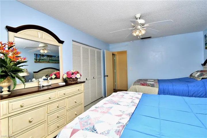 Bedroom featuring ceiling fan, a textured ceiling, and a closet