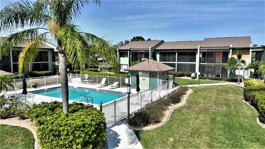 View of swimming pool with a yard