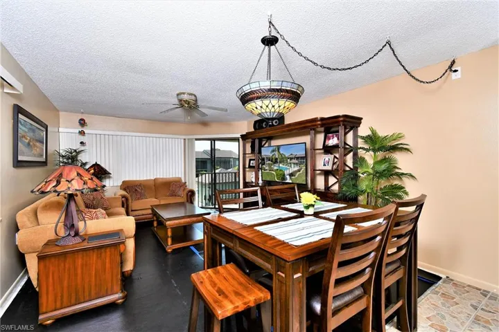 Dining area with ceiling fan and a textured ceiling