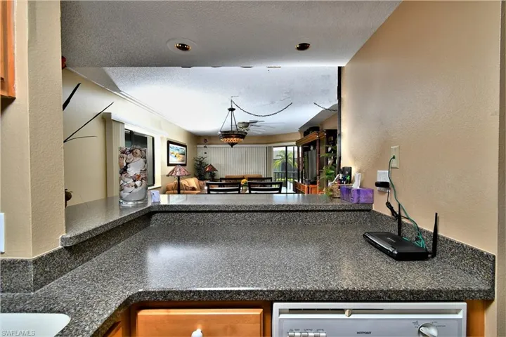 Kitchen featuring a textured ceiling and stainless steel dishwasher and breakfast nook