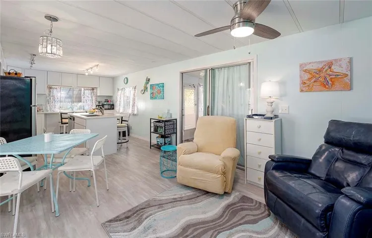 Living area featuring a ceiling fan and light wood finished floors