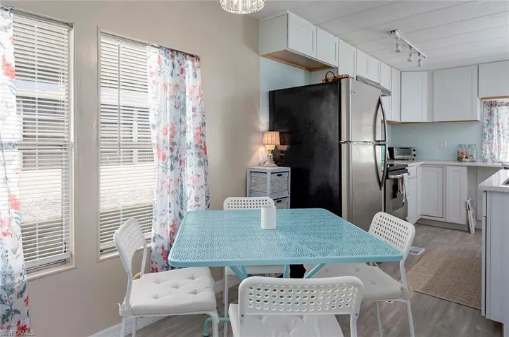 Dining space featuring rail lighting and light wood finished floors
