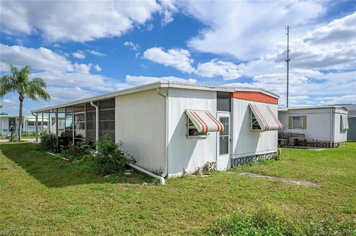 View of side of home featuring a yard