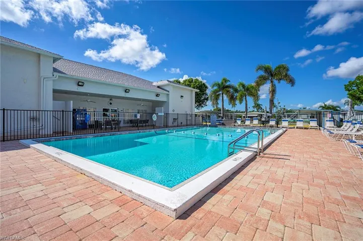 Pool with a patio, fence, and a ceiling fan
