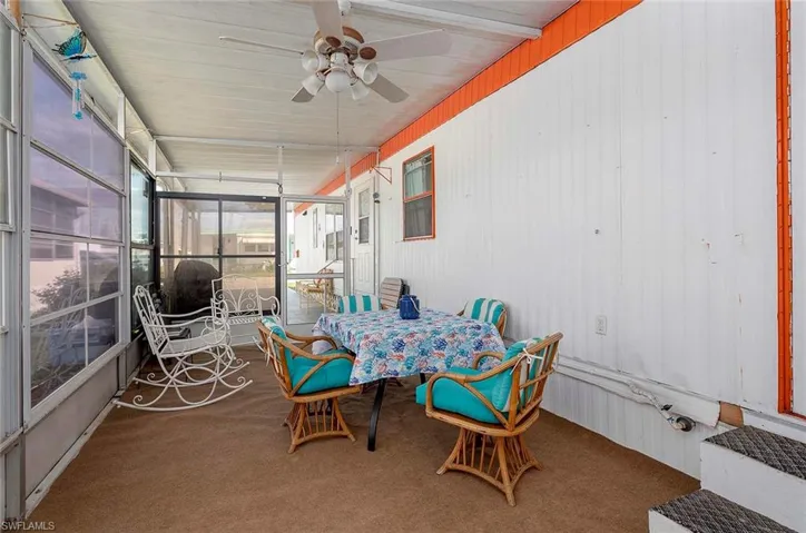 Sunroom featuring outdoor dining area and ceiling fan