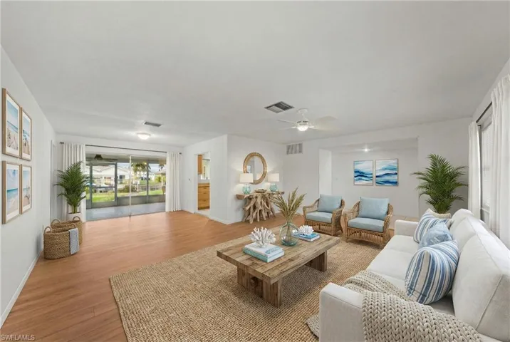 Living area with wood finished floors and ceiling fan