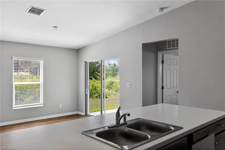 Kitchen island with a double basin sink and a chrome faucet