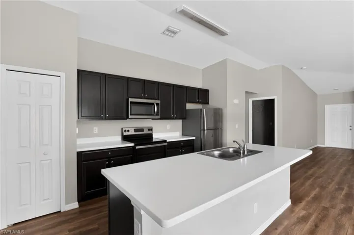 Kitchen with a central island featuring a double-basin sink