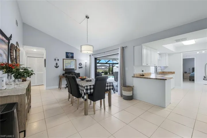 Dining overlooking pool and open to the kitchen