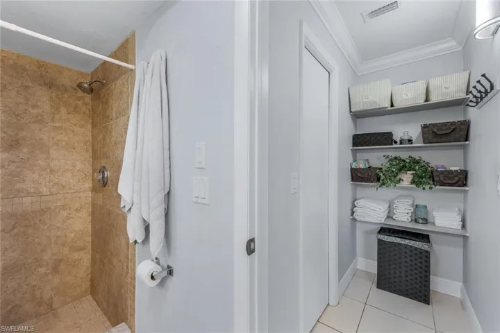 main bath with extra storage and a walk-in closet
