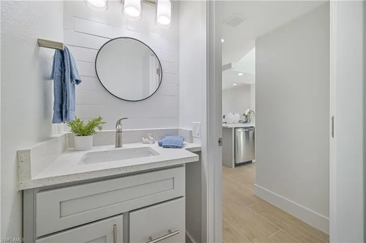 Bathroom featuring hardwood / wood-style floors and vanity with extensive cabinet space