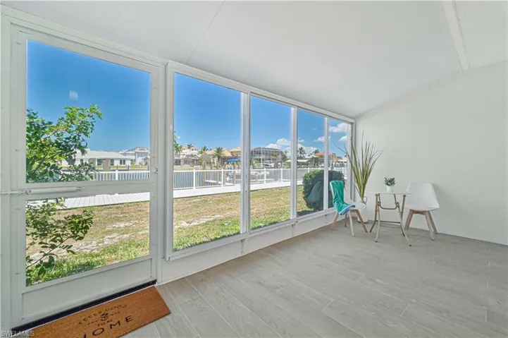 Sunroom with a wealth of natural light and lofted ceiling