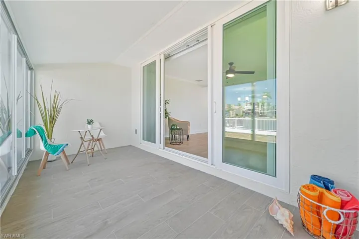 Unfurnished sunroom featuring ceiling fan