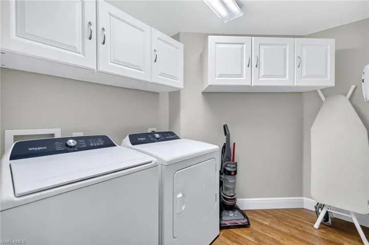 Laundry room with cabinetry.