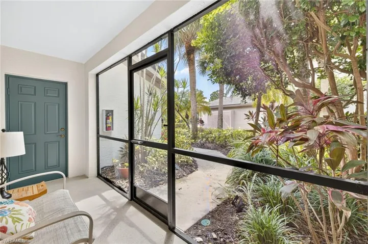 Screened entryway and sitting area.