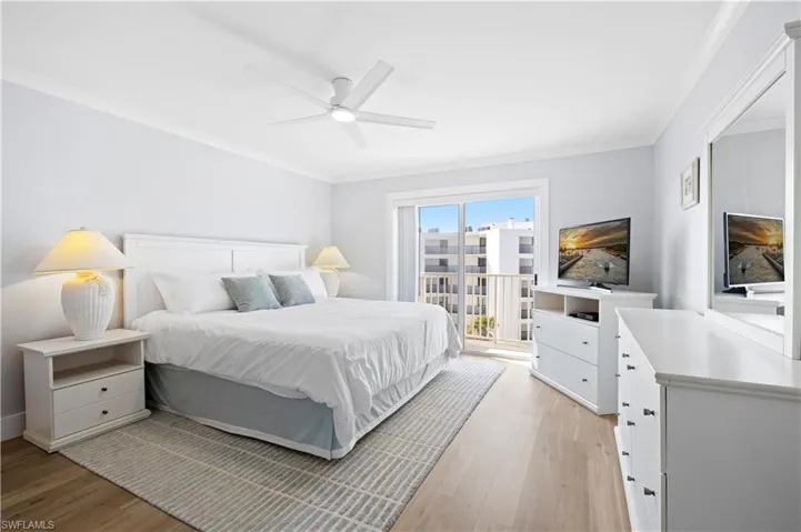 Bedroom featuring light wood-style floors, crown molding, ceiling fan, and access to exterior