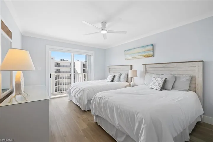 Bedroom with access to exterior, ornamental molding, wood finished floors, and a ceiling fan