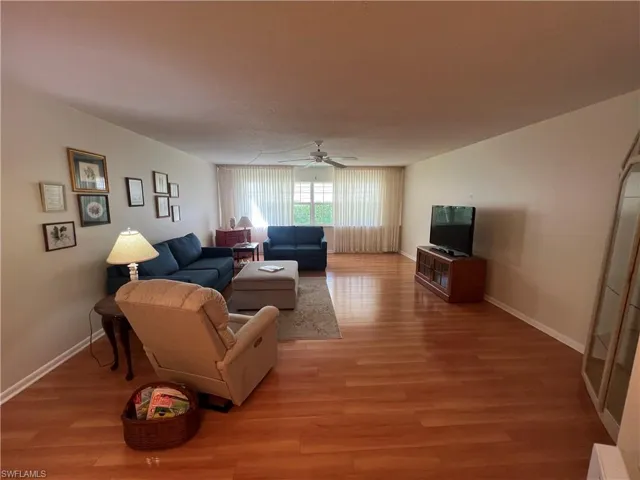 Living room featuring hardwood / wood-style floors and ceiling fan
