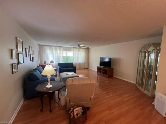 Living room featuring light hardwood / wood-style floors and ceiling fan