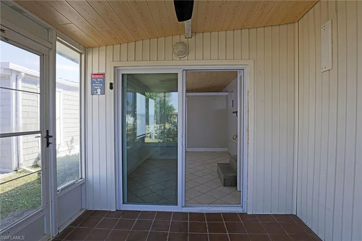 Doorway to property featuring a sunroom