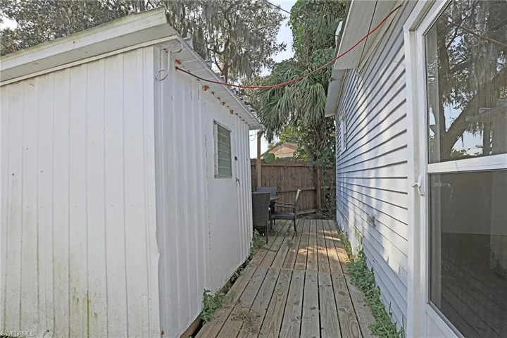 View of side of home with a deck and an outdoor structure