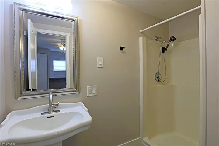 Full bathroom with a shower stall and a sink