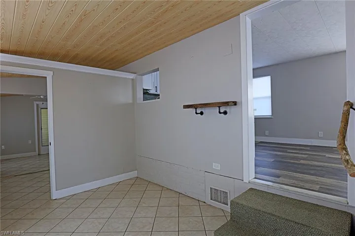 Empty room featuring wood ceiling