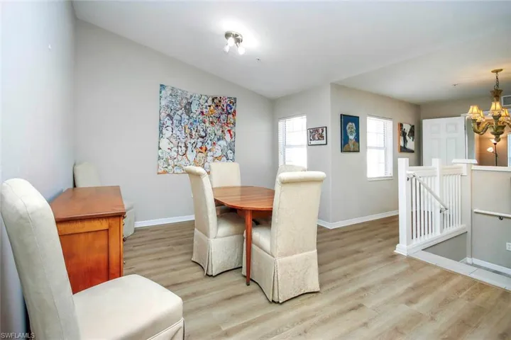 Dining space with light wood-style flooring and a chandelier