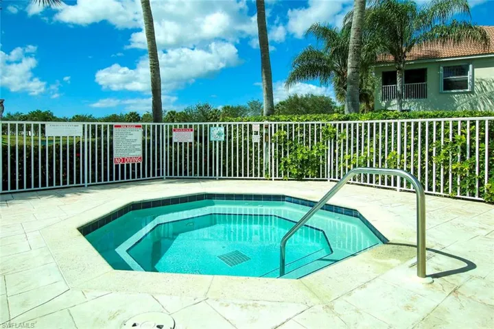 View of pool featuring a community hot tub and a patio