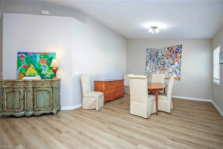 Dining room featuring light wood-style flooring and baseboards
