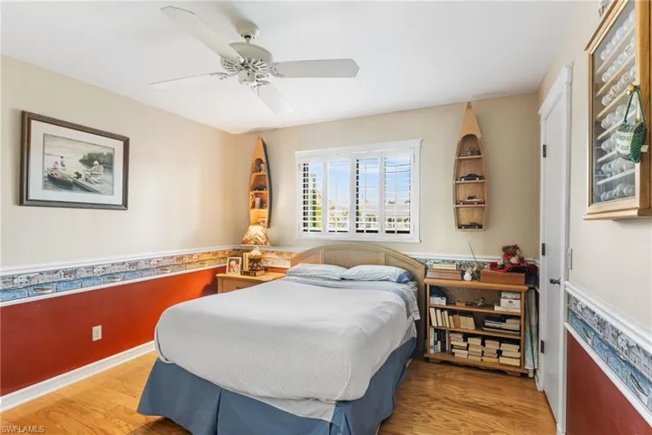 Bedroom with ceiling fan and wood finished floors