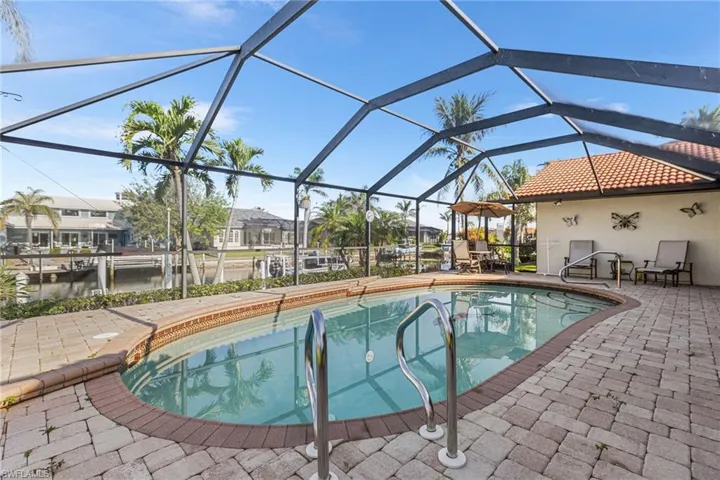 Pool with a residential view, a lanai, and a patio area