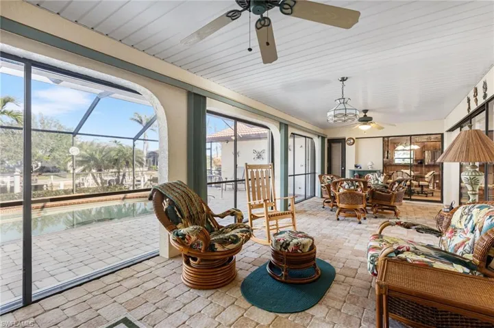 Sunroom / solarium featuring plenty of natural light, an outdoor hangout area, and ceiling fan