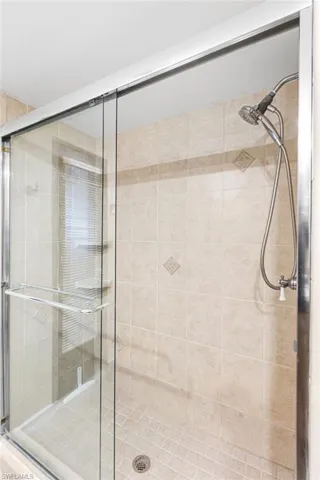 Full bathroom with a shower stall