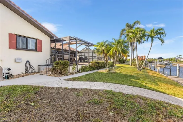 View of yard featuring a lanai and a boat dock