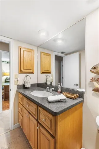 Half bath featuring visible vents, tile patterned flooring, and vanity