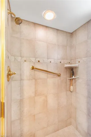 Full bath featuring tiled shower