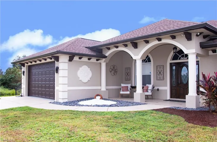 Mediterranean / spanish-style house featuring a porch, a front lawn, and a garage