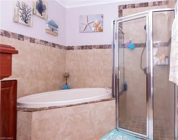 Bathroom with separate shower and tub and ornamental molding