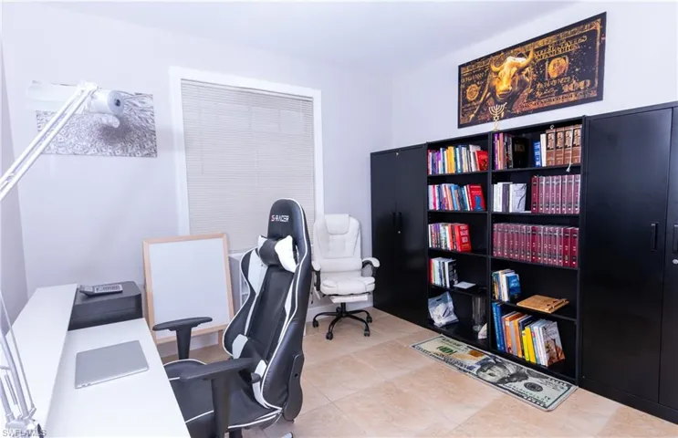 Home office with light tile patterned flooring