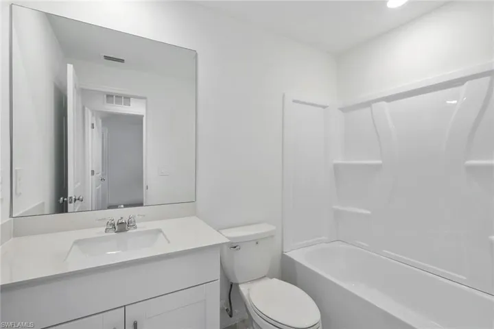 Bathroom with vanity and tub / shower combination