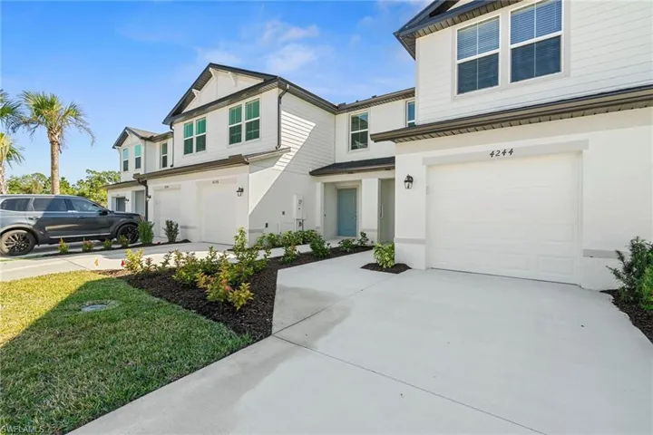 View of front of home with an attached garage and concrete driveway