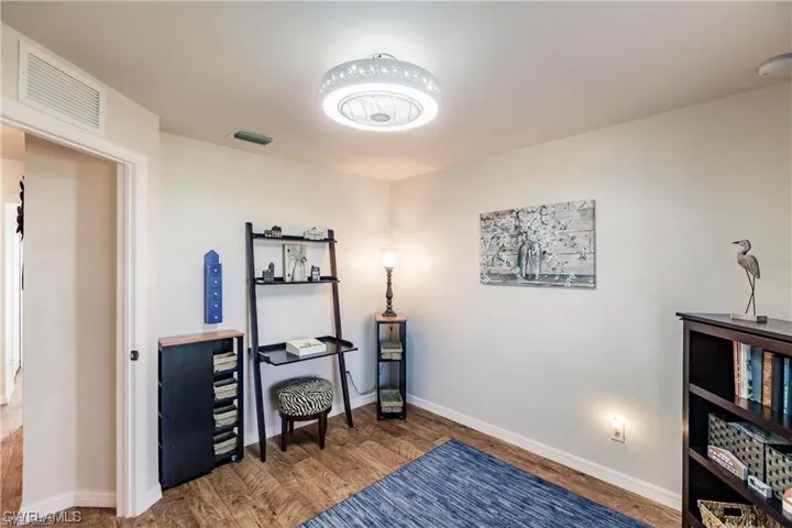 Office featuring wood finished floors and baseboards