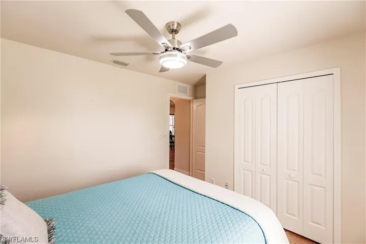 Bedroom with ceiling fan and a closet